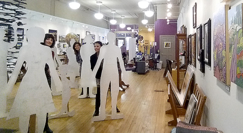 The Matthews' staff posing with the blank flat people--created by Ava Sauter.