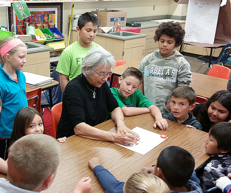 Halsey instructing the kids in copper embossing.