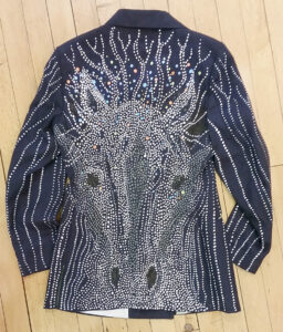 View of the back of Carmen Dolen's hand-painted coat. 